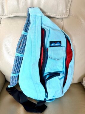 Kavu Light Blue Sling Pack with Red Interior and Patterned Strap
